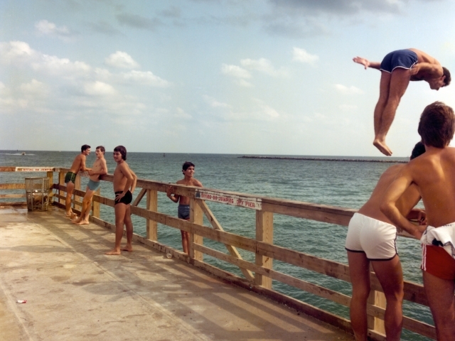 boys diving off of a dock
