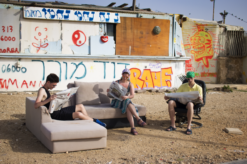 people sitting on a couch outside