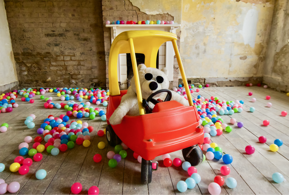 stuffed animal polar bear in a child's play car