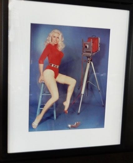 image of an image of a woman wearing a red bodysuit on a stool