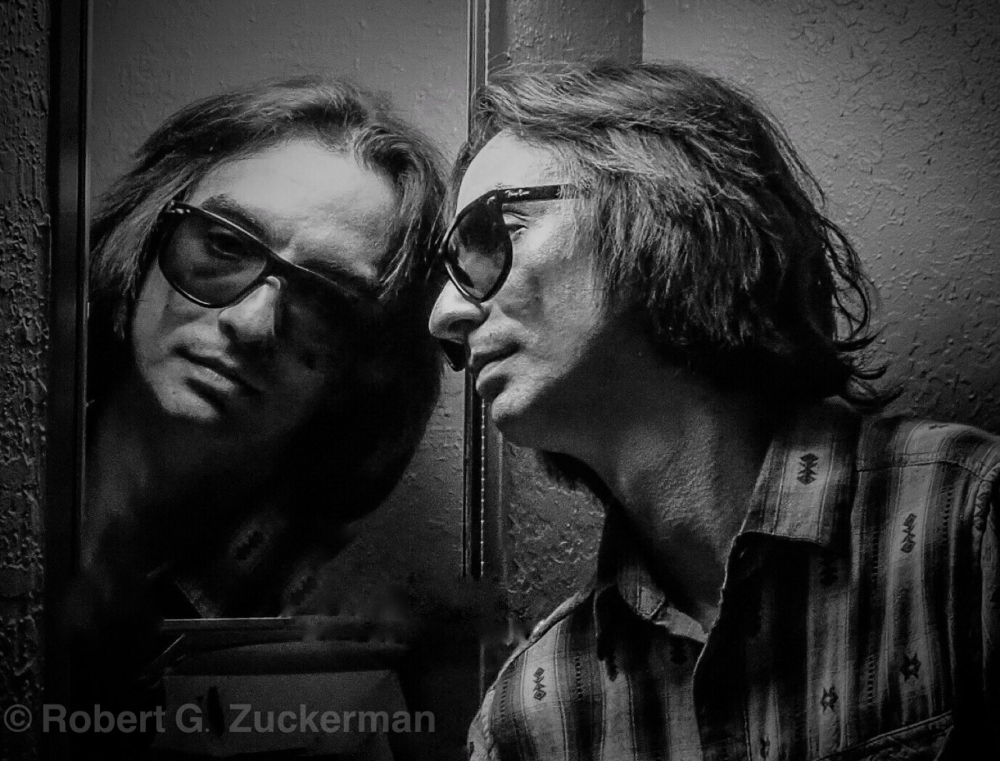 man looking in mirror with reflection