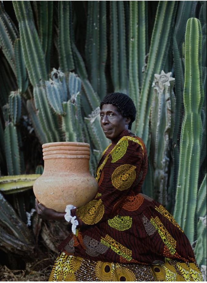woman holding a clay pot