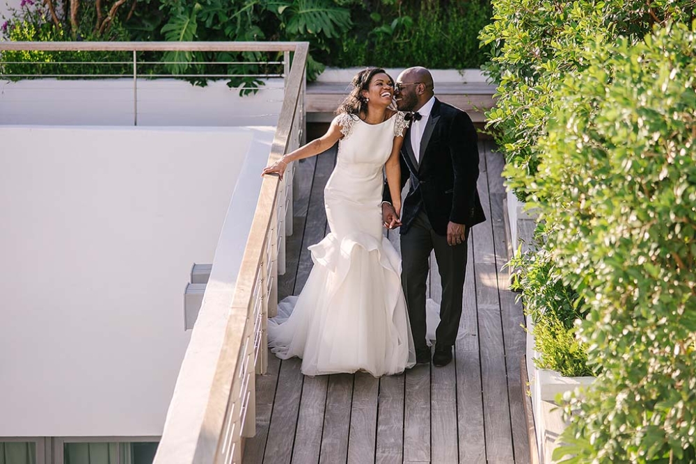 bride and groom walking down boardwalk