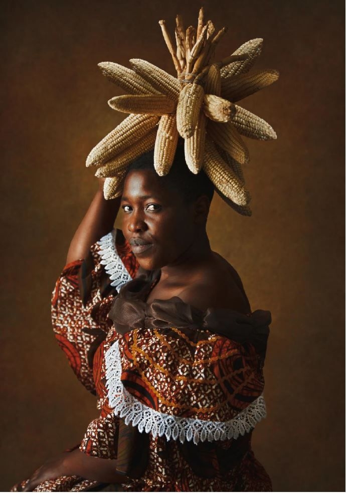 woman posing with ears of corn on her head