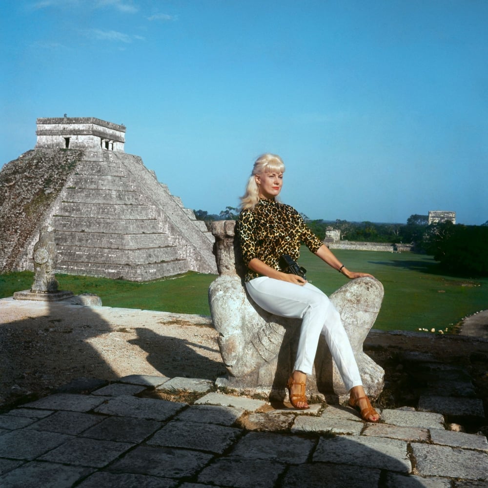 woman sitting in front of a pyramid