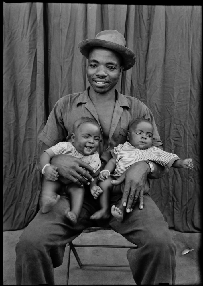 b/w man holding two babies by Seydou Keita