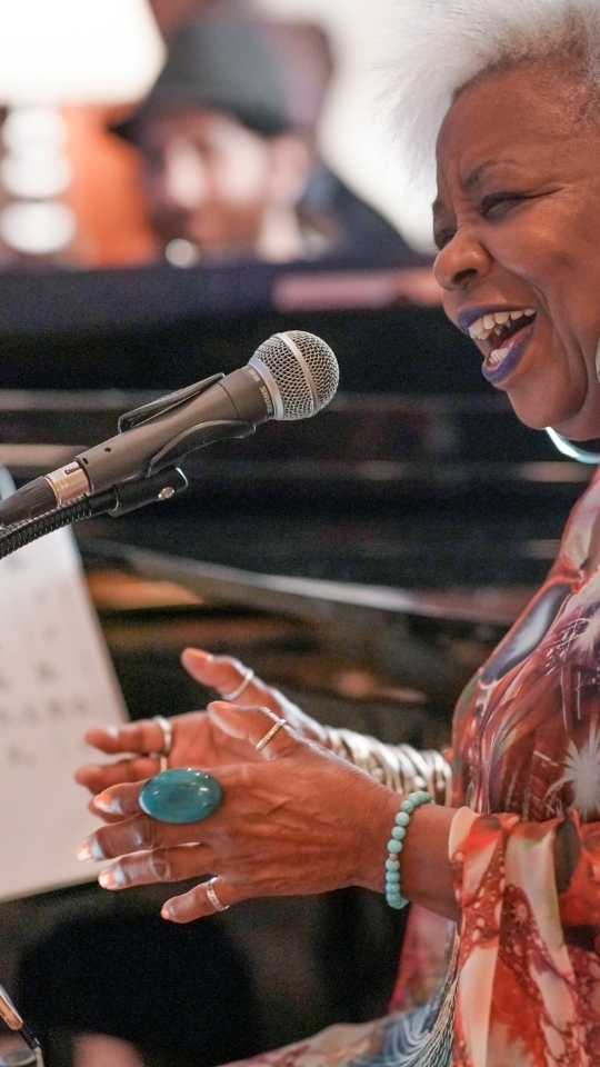 woman singing and playing piano