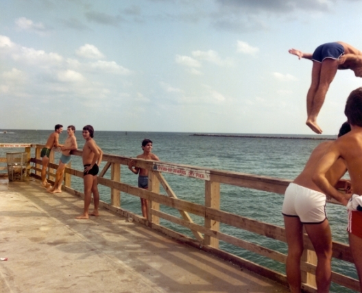 boys diving off of a dock