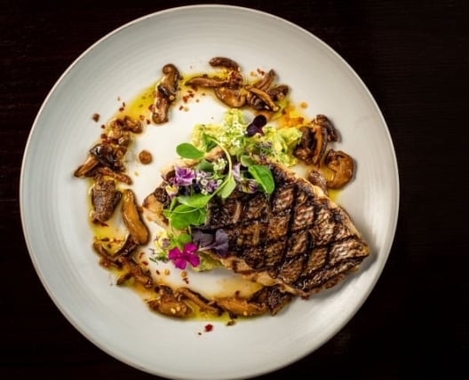 Grilled fish with mushrooms and garnish