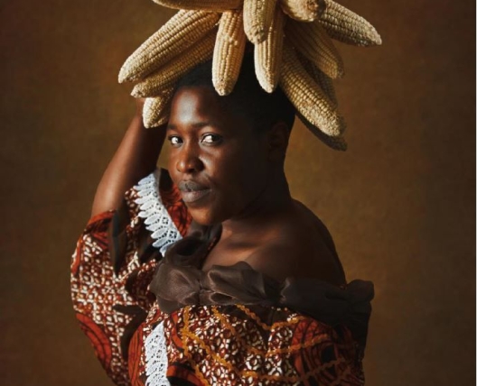 woman posing with ears of corn on her head